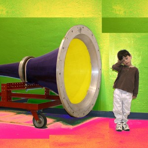 Child bored by a giant loud speaker.
