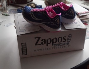 Purple Running Shoes atop a Zappos Box